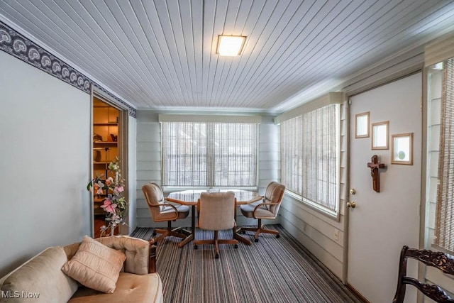 sunroom featuring plenty of natural light and wood ceiling