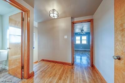 corridor with light hardwood / wood-style flooring