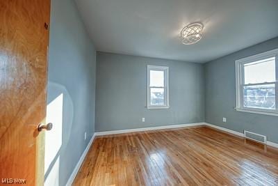 empty room with hardwood / wood-style floors