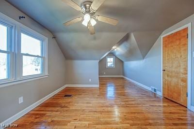 bonus room with vaulted ceiling, ceiling fan, and light hardwood / wood-style floors