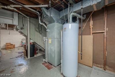 utility room featuring heating unit and gas water heater