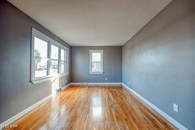 spare room with light hardwood / wood-style floors