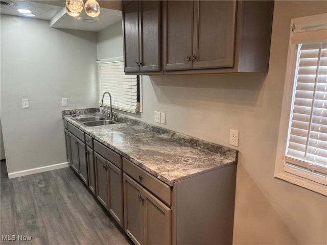 kitchen featuring sink and dark wood-type flooring