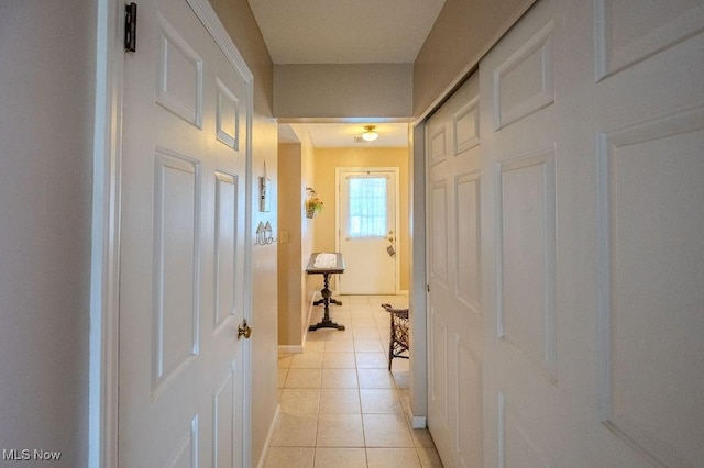 hall with light tile patterned floors