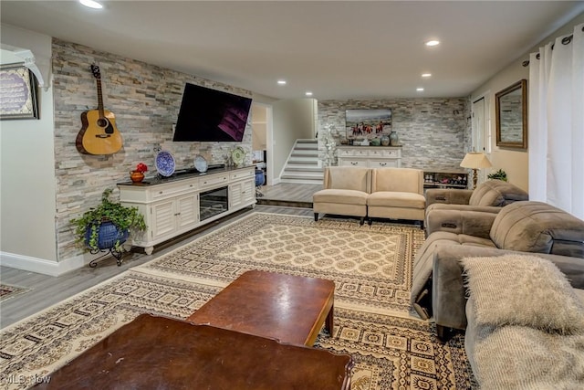 living room with a fireplace and wood-type flooring