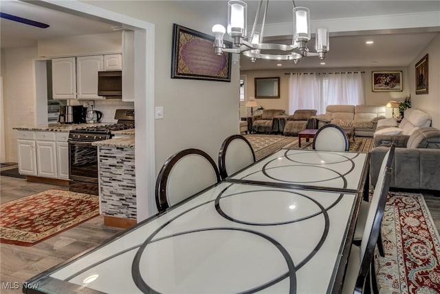 dining room featuring hardwood / wood-style floors and a chandelier