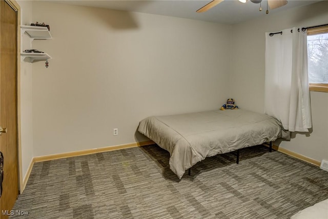 bedroom featuring ceiling fan and carpet