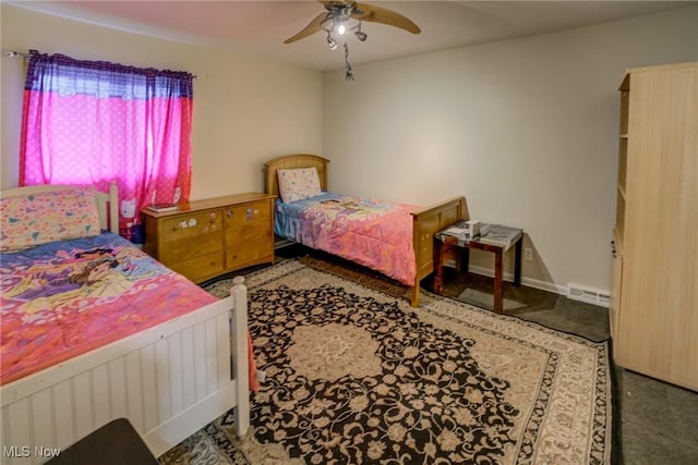 bedroom featuring dark colored carpet and ceiling fan