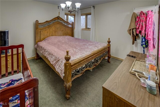 carpeted bedroom with a chandelier