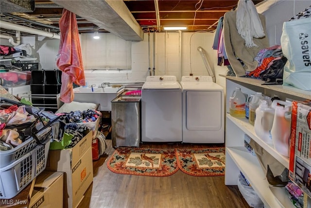 washroom featuring dark wood-type flooring, separate washer and dryer, and sink