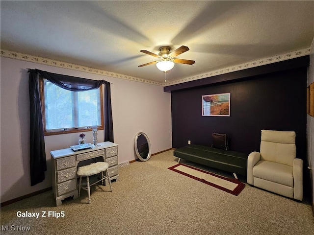 office space featuring ceiling fan, light carpet, and a textured ceiling