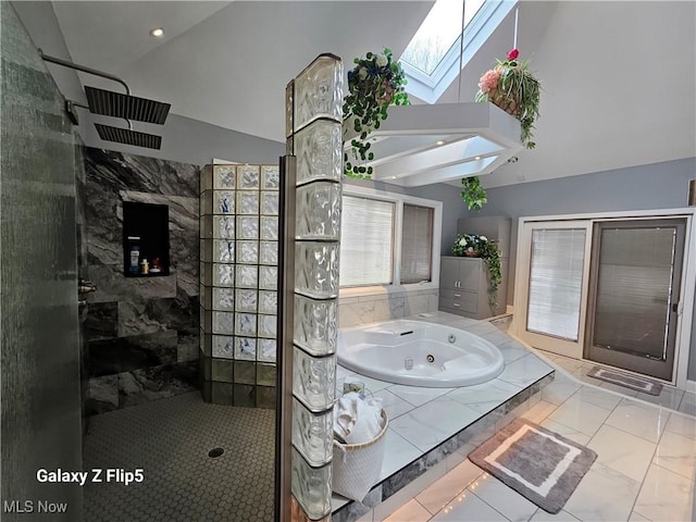 bathroom featuring lofted ceiling with skylight and shower with separate bathtub