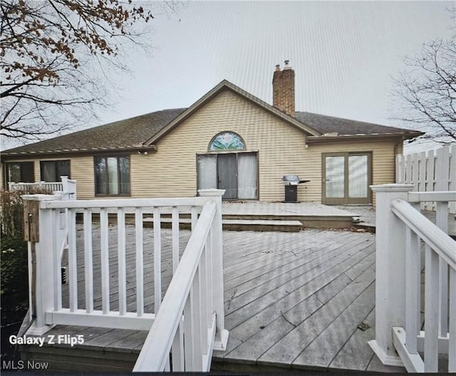 rear view of property with a wooden deck