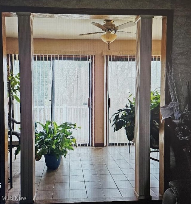 doorway to outside featuring tile patterned flooring and ceiling fan