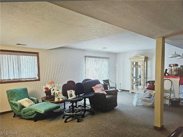 carpeted living room featuring a textured ceiling