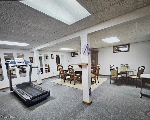 workout area featuring a paneled ceiling and carpet floors