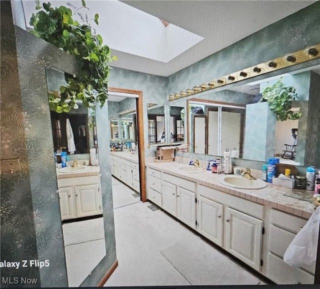 bathroom with vanity and a skylight