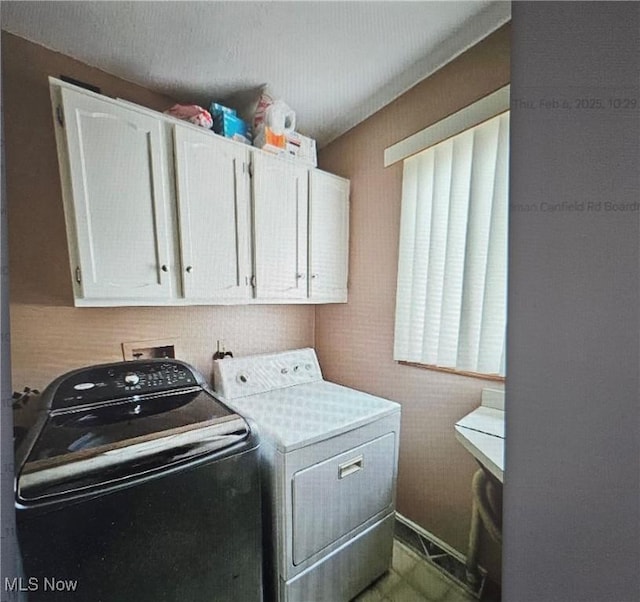 laundry area featuring cabinets and washing machine and dryer