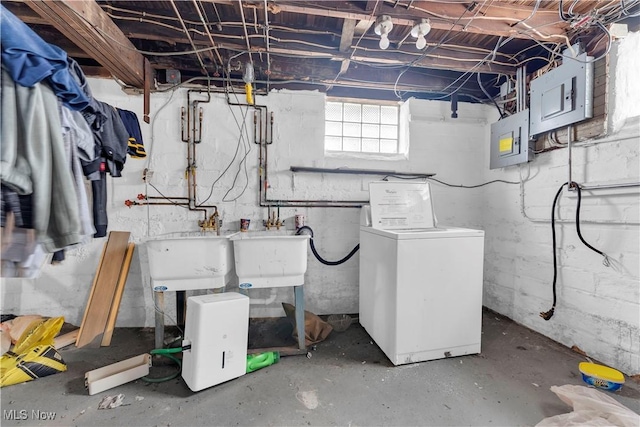 basement with sink, electric panel, and independent washer and dryer