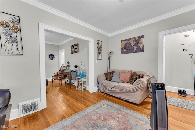 living room with crown molding and wood-type flooring