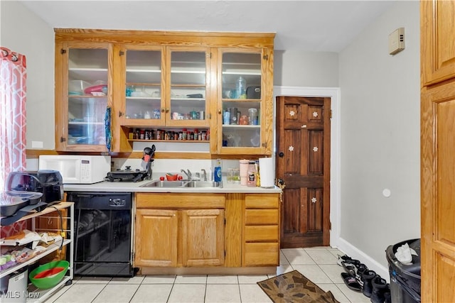 kitchen featuring dishwasher, light tile patterned flooring, and sink