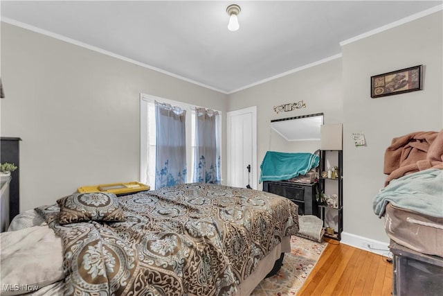 bedroom featuring hardwood / wood-style flooring and ornamental molding