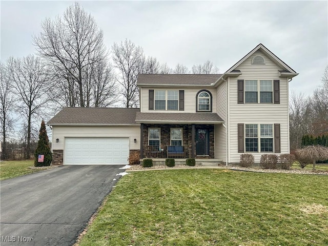 view of front property featuring a garage, a porch, and a front yard