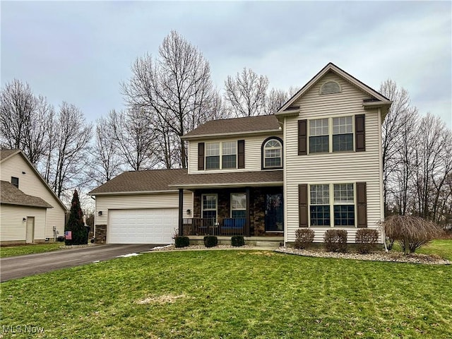 view of front property featuring a garage, covered porch, and a front lawn