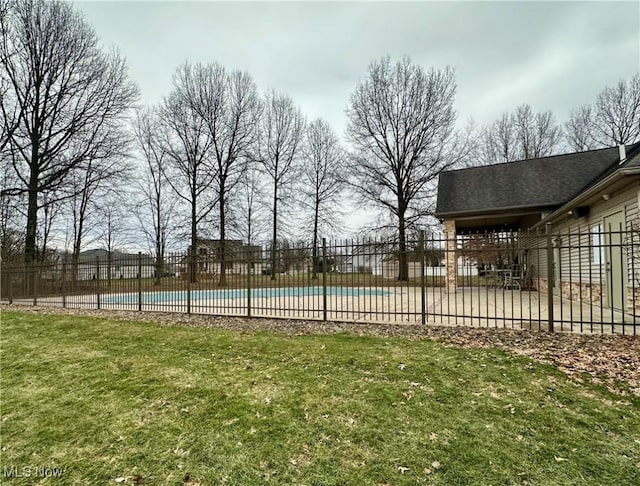 view of swimming pool with a patio area and a lawn