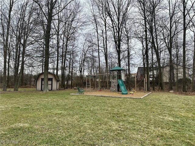 view of yard with a playground, an outdoor structure, and a shed