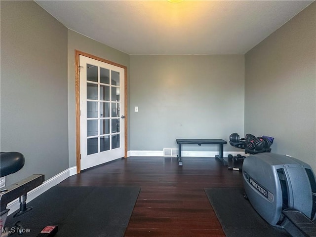 exercise room with dark hardwood / wood-style floors