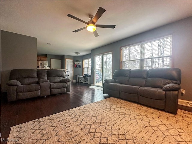 living room featuring hardwood / wood-style flooring and ceiling fan