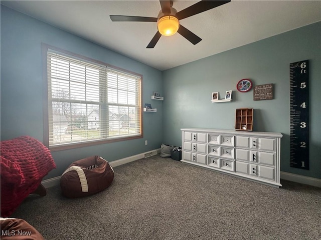 interior space featuring carpet floors, ceiling fan, visible vents, and baseboards