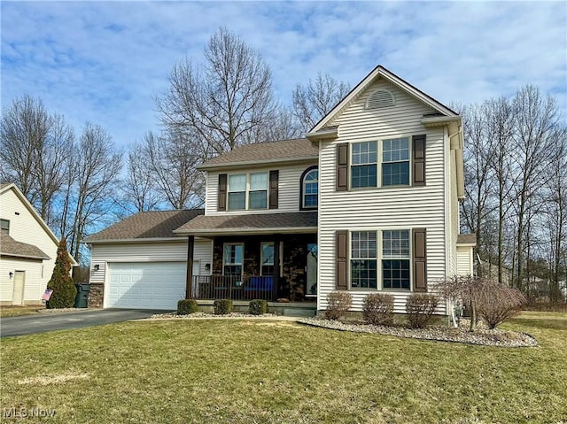 traditional-style home featuring an attached garage, aphalt driveway, a porch, and a front yard