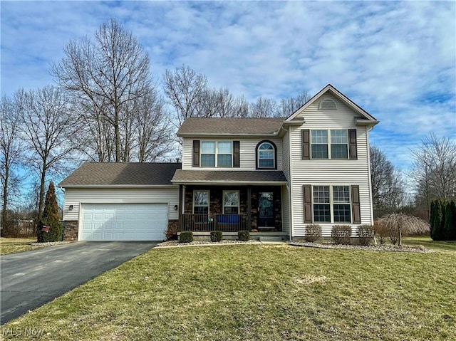 traditional-style house with a garage, driveway, a porch, and a front yard