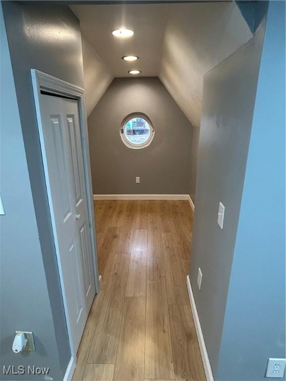 interior space featuring vaulted ceiling and light wood-type flooring