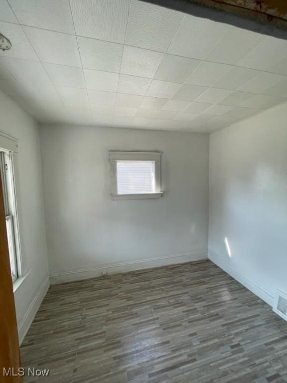 unfurnished room with wood-type flooring