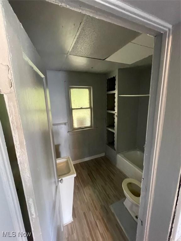 bathroom featuring vanity, hardwood / wood-style floors, a tub, and toilet