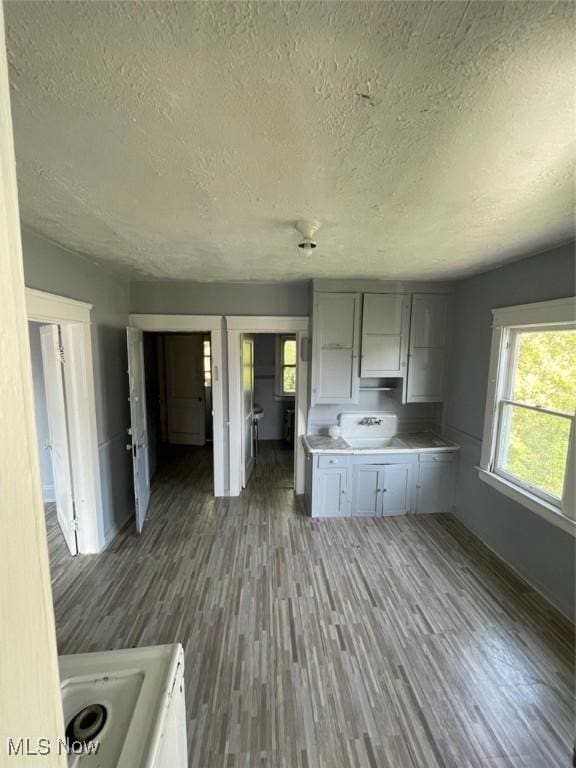 kitchen with range, dark hardwood / wood-style floors, and a textured ceiling