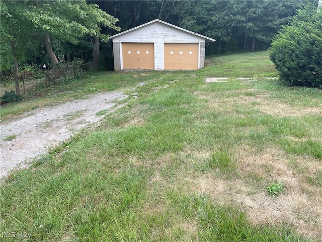 view of yard featuring an outbuilding and a garage