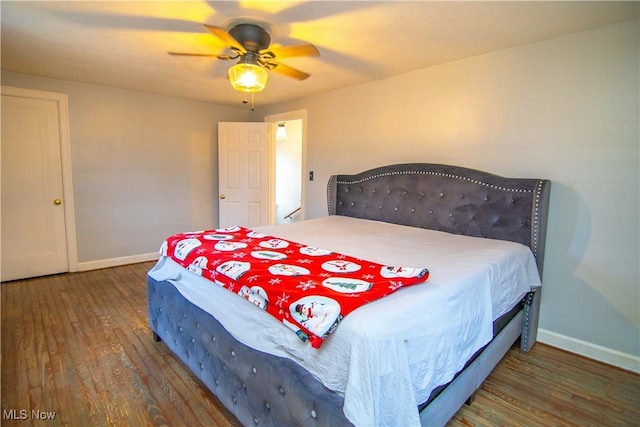 bedroom with ceiling fan and dark hardwood / wood-style flooring