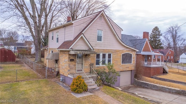 view of front of house with a garage and a front yard