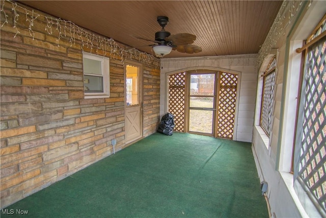 unfurnished sunroom with ceiling fan and wood ceiling