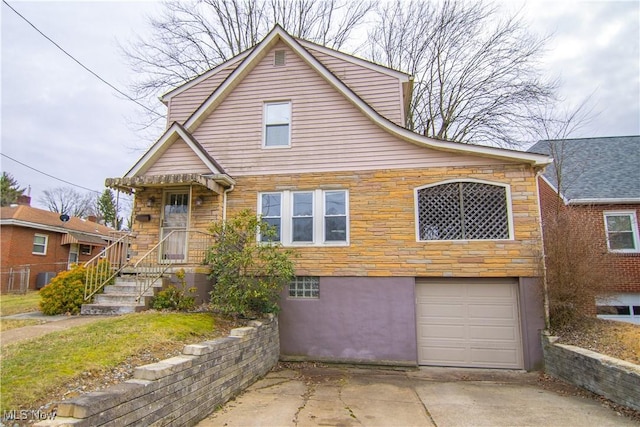 view of front of home featuring central AC unit and a garage