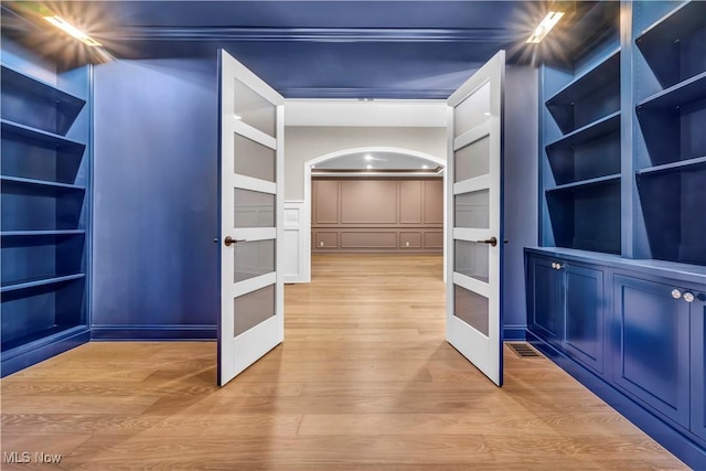 spacious closet featuring light wood-type flooring and french doors