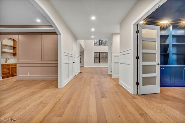 hall with sink and light hardwood / wood-style floors