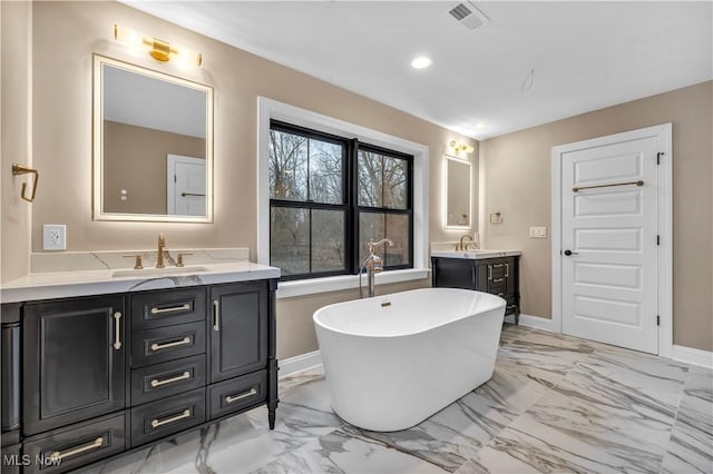 bathroom with vanity and a bathing tub