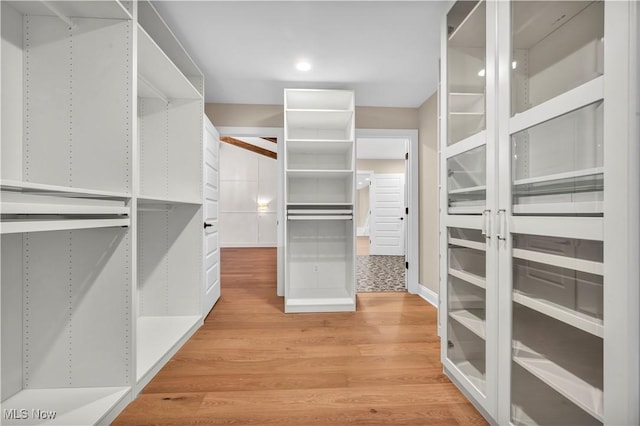 spacious closet with light hardwood / wood-style floors