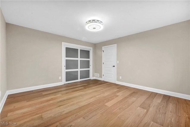 spare room featuring light hardwood / wood-style floors