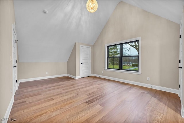 additional living space with lofted ceiling and light hardwood / wood-style floors